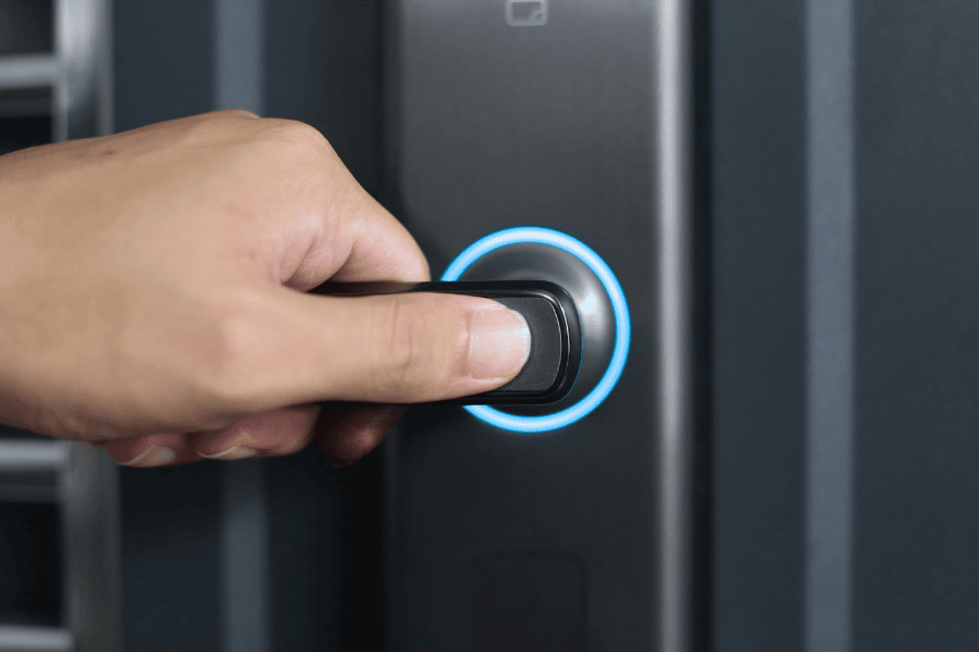 up close shot of a hand grasping the door handle with a smart lock 